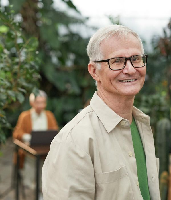 Man standing in a calm, balanced pose against a marble-like background.